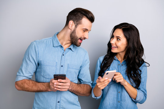 Close up photo wondered she her he him his lady guy telephone smart phone hands arms read reader news look interest eyes wear casual jeans denim shirts outfit clothes isolated light grey background