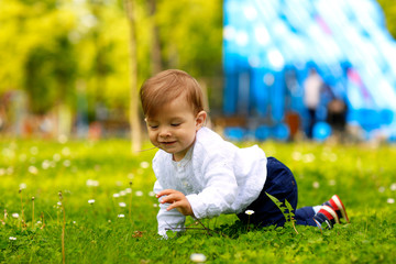 Portrait of beautiful smiling cute baby boy in park