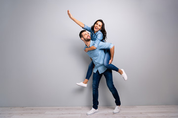 Full length body size photo funky cheer she her he him his lady guy piggyback ride walk meet...