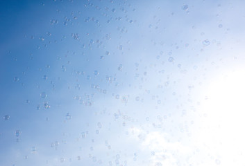 Soap bubbles fly in the blue sky