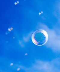 Soap bubbles fly in the blue sky