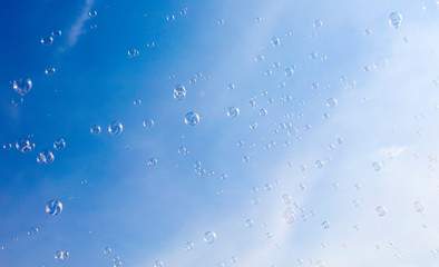 Soap bubbles fly in the blue sky