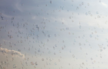 Soap bubbles fly in the blue sky