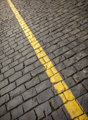 Yellow line on paving stone as abstract background