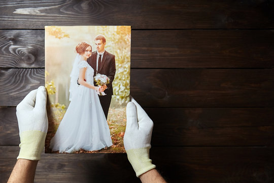 Photo of a wedding couple printed on canvas. Brown wooden wall