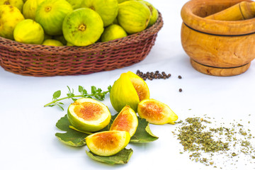 grenn figs opened in closeup on white background.