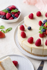 Piece of birthday cake with whole cake on white table