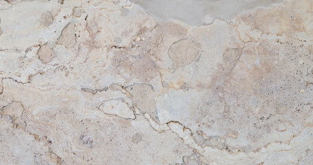 Full frame texture background of a weathered and abstract light brown stone slab.