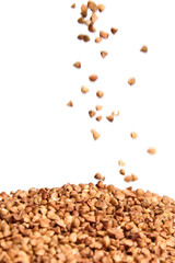Buckwheat grains. Heap of kernel on white background. Selective focus