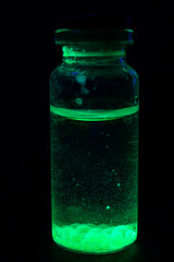 Vial yellow fluorescent paint in the UV-blacklight