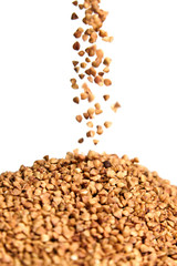 Buckwheat grains. Heap of kernel on white background. Selective focus