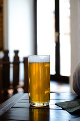 glass of beer on wooden table