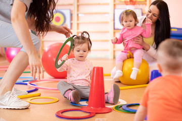 Nursery babies group doing sport in fitness club