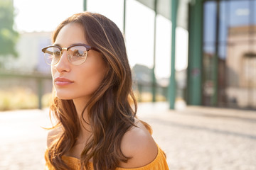 Woman with spectacles thinking - Powered by Adobe
