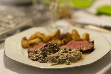 Beef tenderloin, morels and ratte potatoes for christmas diner. French speciality for festive Christmas celebration.