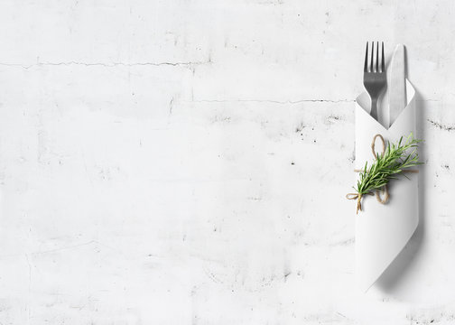 Cutlery with rosemary on marble background