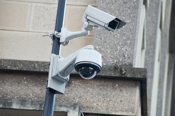 closeup of white security cameras of security on urban background