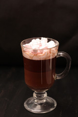 hot drink in a glass cup with pink marshmallows and white box with a transparent cover in the form of heart with cookies