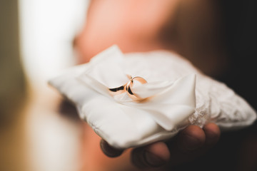 Obraz na płótnie Canvas Wedding rings on ceremony at church. Macro.