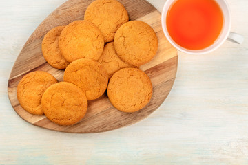 Ginger cookies, shot from the top with a cup of tea and copy space