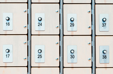 Lockers with electronic locks and fingerprint scanners in modern bright gym.