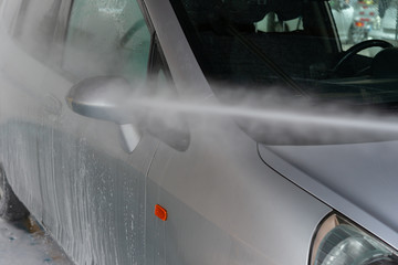 washing a car with soapy liquid