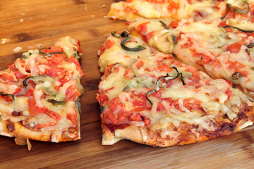 Slices of pizza on wooden table