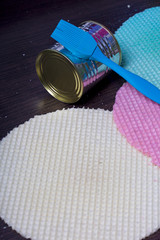 Round wafer cakes of different colors. For making waffle cake. Nearby there is a can of condensed milk to soak the cakes, and a culinary tassel. On a dark background.