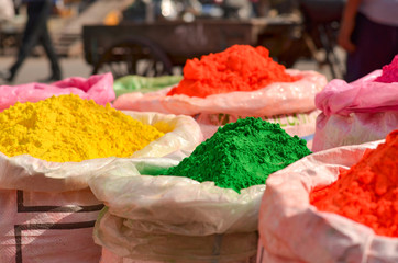 gunny bags of different colored herbal organic colors gulal on display in old delhi for holi celebrations