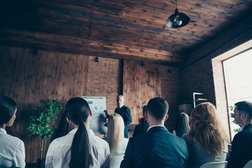 Crowd of nice stylish trendy serious sharks audience attending corporate forum listening top management company ceo boss chief specialist expert at industrial loft interior work place space indoors