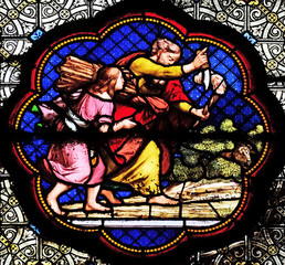 Fototapeta na wymiar Isaac carrying the wood of the sacrife, prefiguration of the carrying of the Cross, stained glass window in the Basilica of Saint Clotilde in Paris, France
