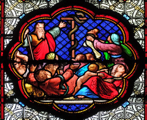 Exposition of the brass serpent in the desert, prefiguration of the Crucifixion, stained glass window in the Basilica of Saint Clotilde in Paris, France 