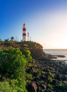 vertical picture of a lighthouse on a cliff during sunset in albion, mauritius
