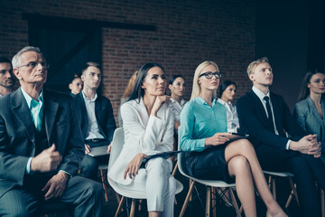 Nice stylish elegant serious focused top managers sharks sitting listening to ceo boss chief startup project attending educative class course at industrial loft interior work place space indoors