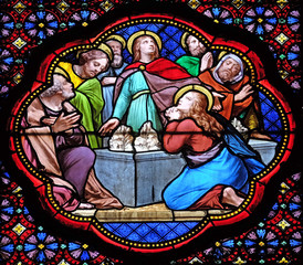 Obraz premium Apostles before empty tomb of Virgin Mary, stained glass window in the Basilica of Saint Clotilde in Paris, France 