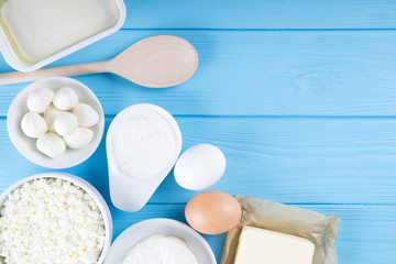 dairy products on blue wooden background, top view