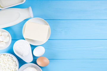 dairy products on blue wooden background, top view