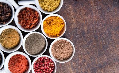 Herbs and spices in ceramic bowls. Aromatic ingredients and natural food additives.