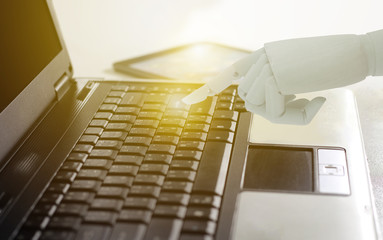 Robot hand use laptop computer, Artificial Intelligence Technology Concept.