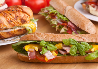 sub sandwiches with meat, vegetables and lettuce