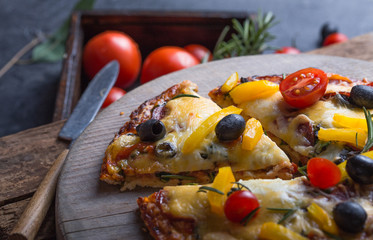 Italian traditional cuisine, pizza, food background. Fresh baked pizza with prosciutto and arugula...