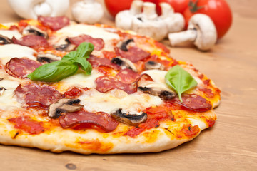 whole pepperoni and mushroom pizza with ingredients