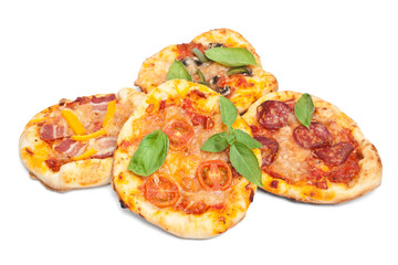 pile of different kind small pizzas isolated on white