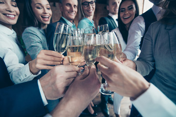Cropped close up photo crowd business people diversity different age race team members she her he him his hold arms hands clink golden wine saying toasts congratulation formal wear jackets shirts