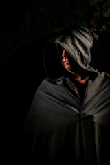 Portrait of a courageous warrior wanderer in a black cloak. Historical fantasy. Halloween.