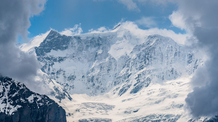 Fototapeta na wymiar Switzerland, panoramic view on snow Alps with clouds