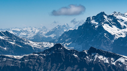 Fototapeta na wymiar Switzerland, panoramic view on snow Alps with clouds