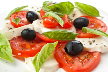 Healthy  Caprese Salad with Mozzarella, Black Olives, Tomatoes and Basil