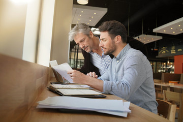 Salesman coworkers going through sales pitch on work trip