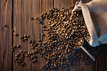 coffee beans on wooden table in bag